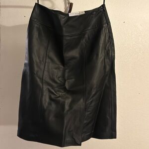 Knee length, Jaclyn Smith black leather skirt, with a 5 inch slit